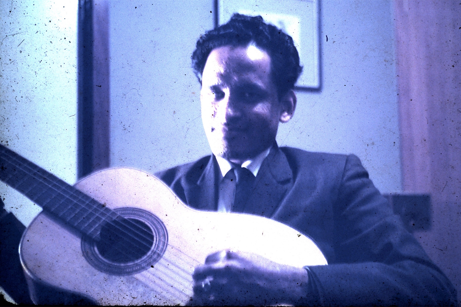 A young Gokulananda Das playing the guitar